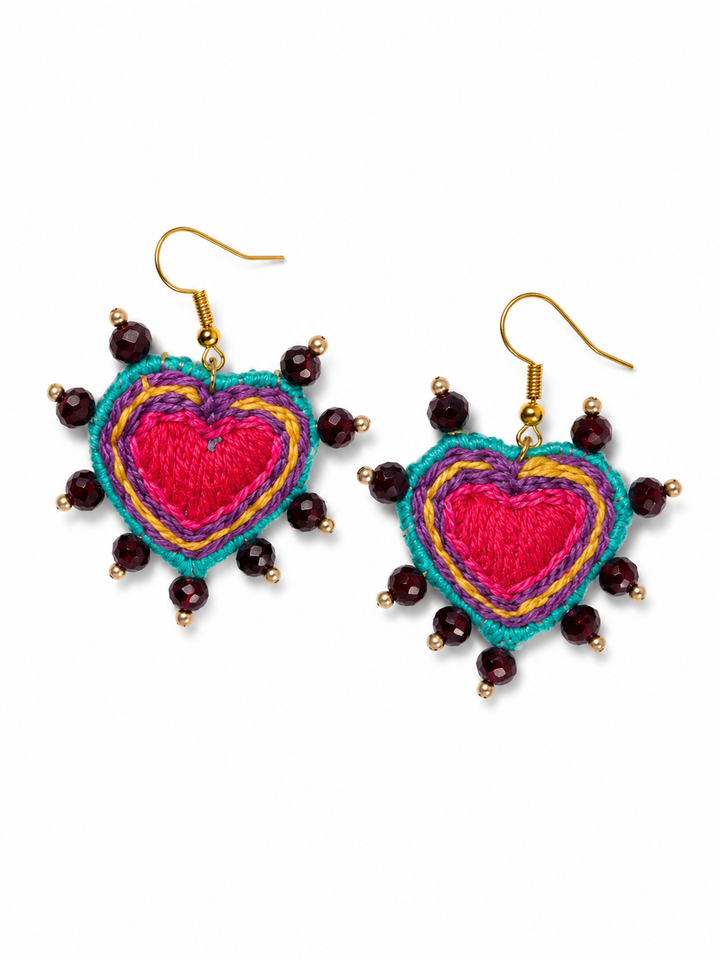 Colorful handmade boho heart earrings with layered embroidery and artisan beadwork on white background