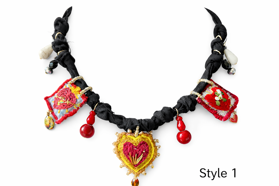 Mexican Milagro necklace featuring hand embroidered Sacred Heart charms and artisan textile cord
