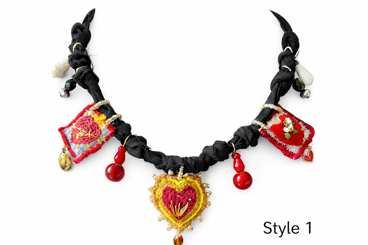 Mexican Milagro necklace featuring hand embroidered Sacred Heart charms and artisan textile cord