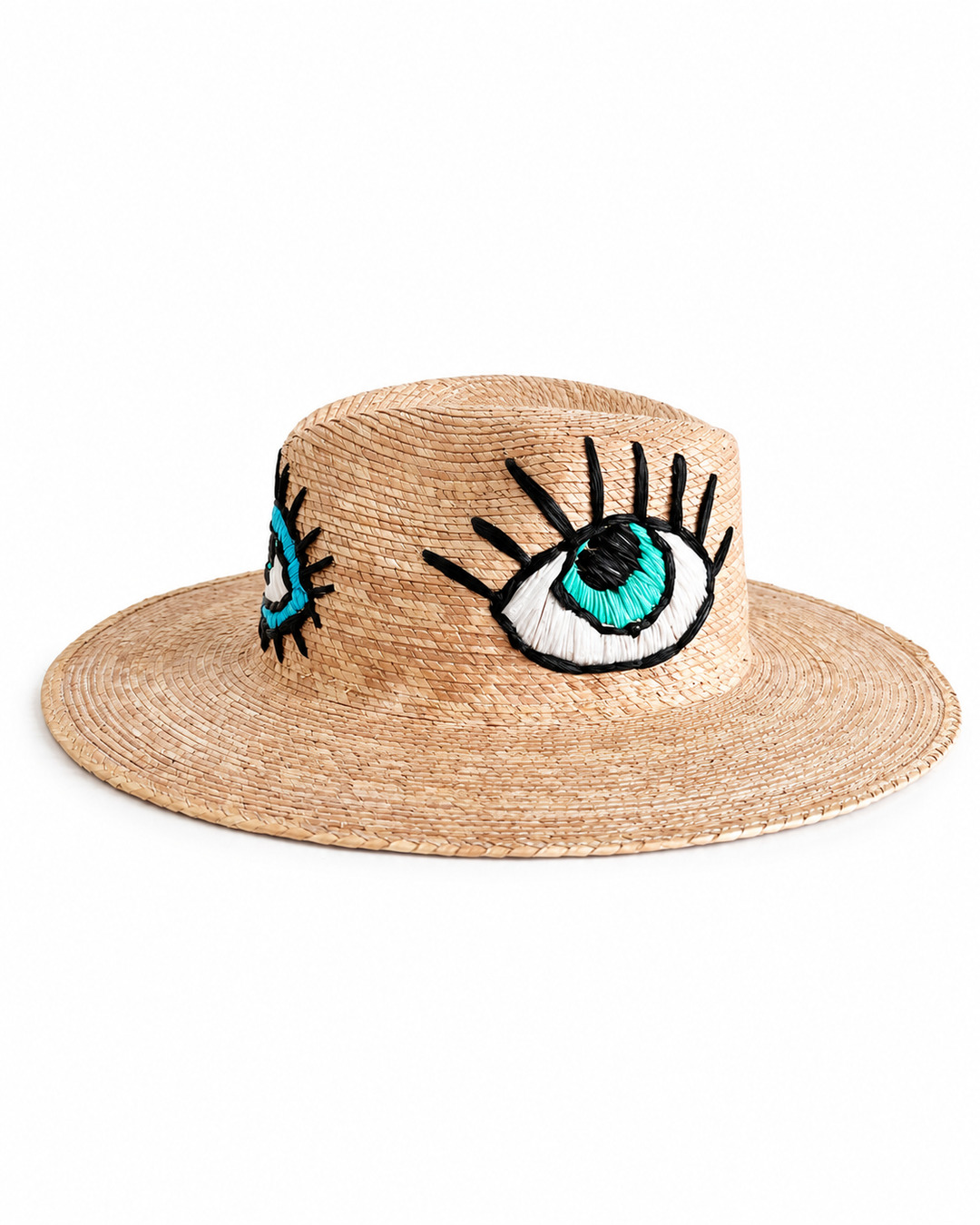 Side view of handmade straw hat with blue embroidered eye design on crown