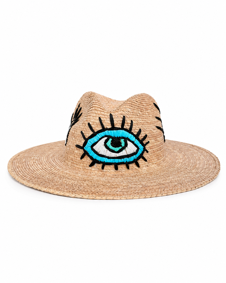 Handmade Mexican straw sun hat with embroidered blue eye motif on white background by Bootsologie 