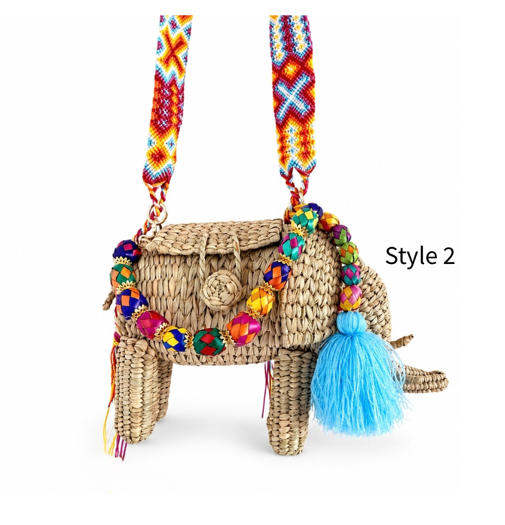  Close up of handmade woven elephant bag showing natural straw texture, colorful beads and artisan-style details