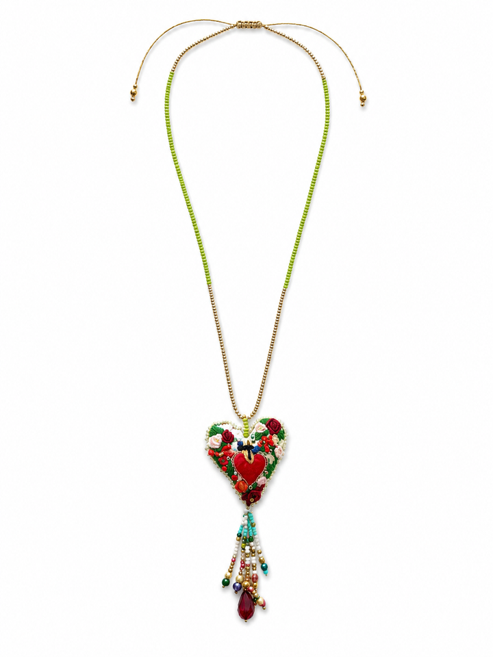 Handmade yellow sacred heart tassel necklace with embroidered heart pendant on white background