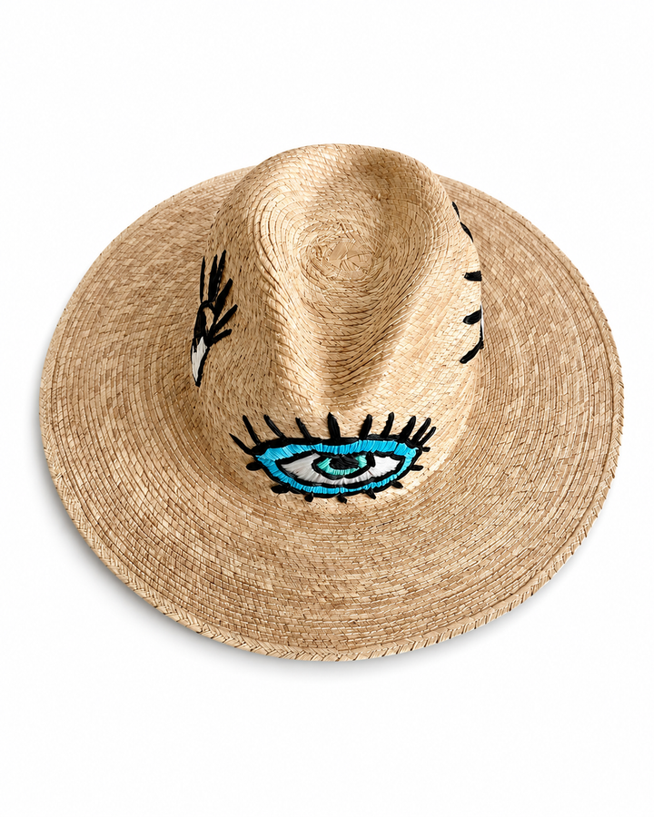 Wide brim straw beach hat with embroidered eye design and natural woven texture