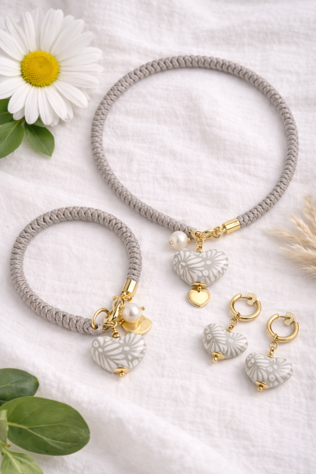 Gray bracelets with gold and pearl accents and matching earrings on a white background with flowers Bootsologie 