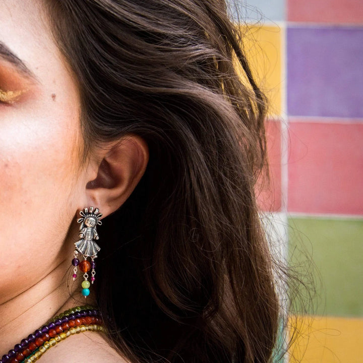 Mexican folk art silver earrings styled on model by Bootsologie