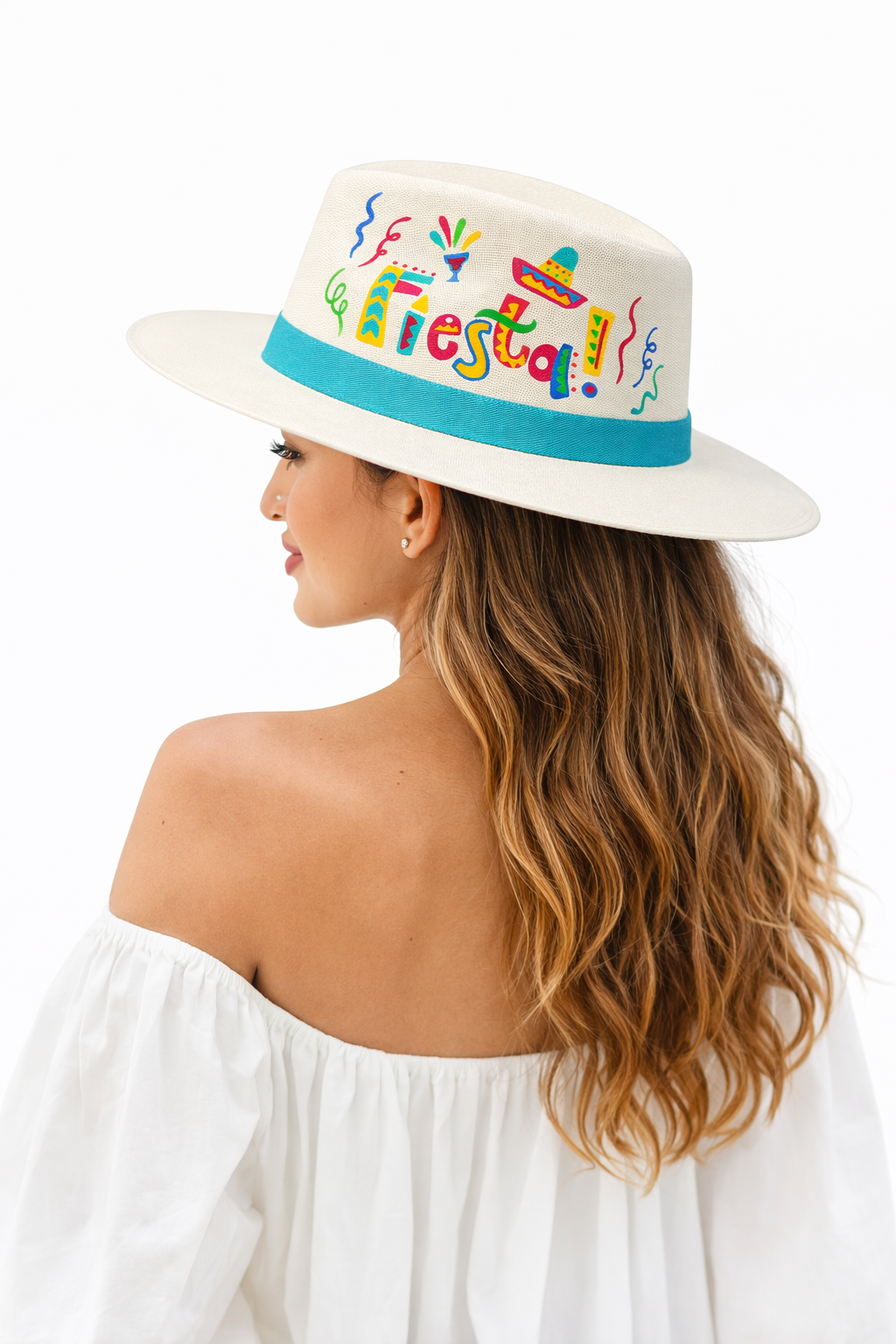 Model wearing a hand painted Mexican Fiesta wide brim hat with colorful piñata and papel picado artwork, styled as a bold artisan statement hat by Bootsologie