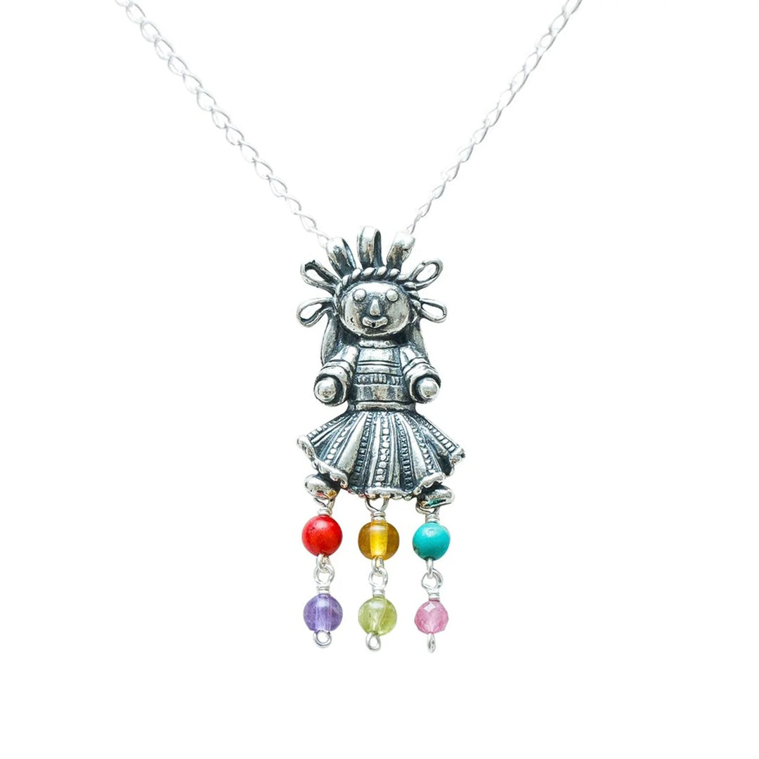 Close-up of Muñeca Mexicana sterling silver pendant and natural gemstones