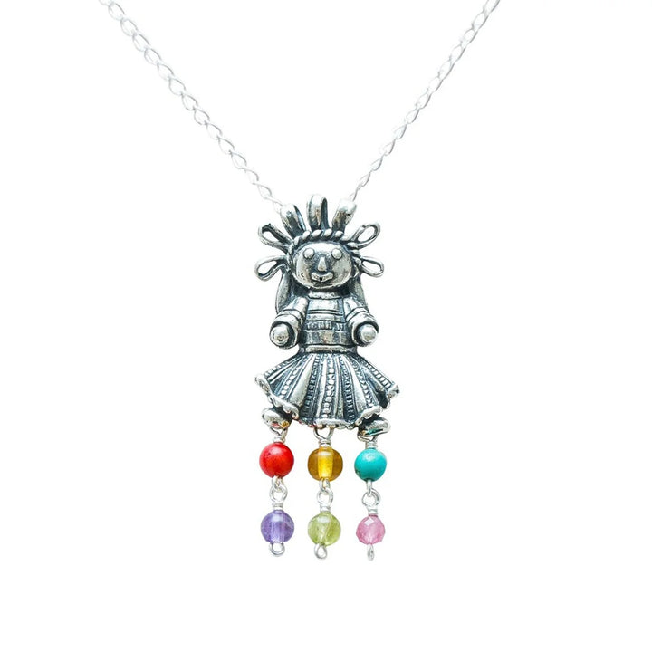 Close-up of Muñeca Mexicana sterling silver pendant and natural gemstones
