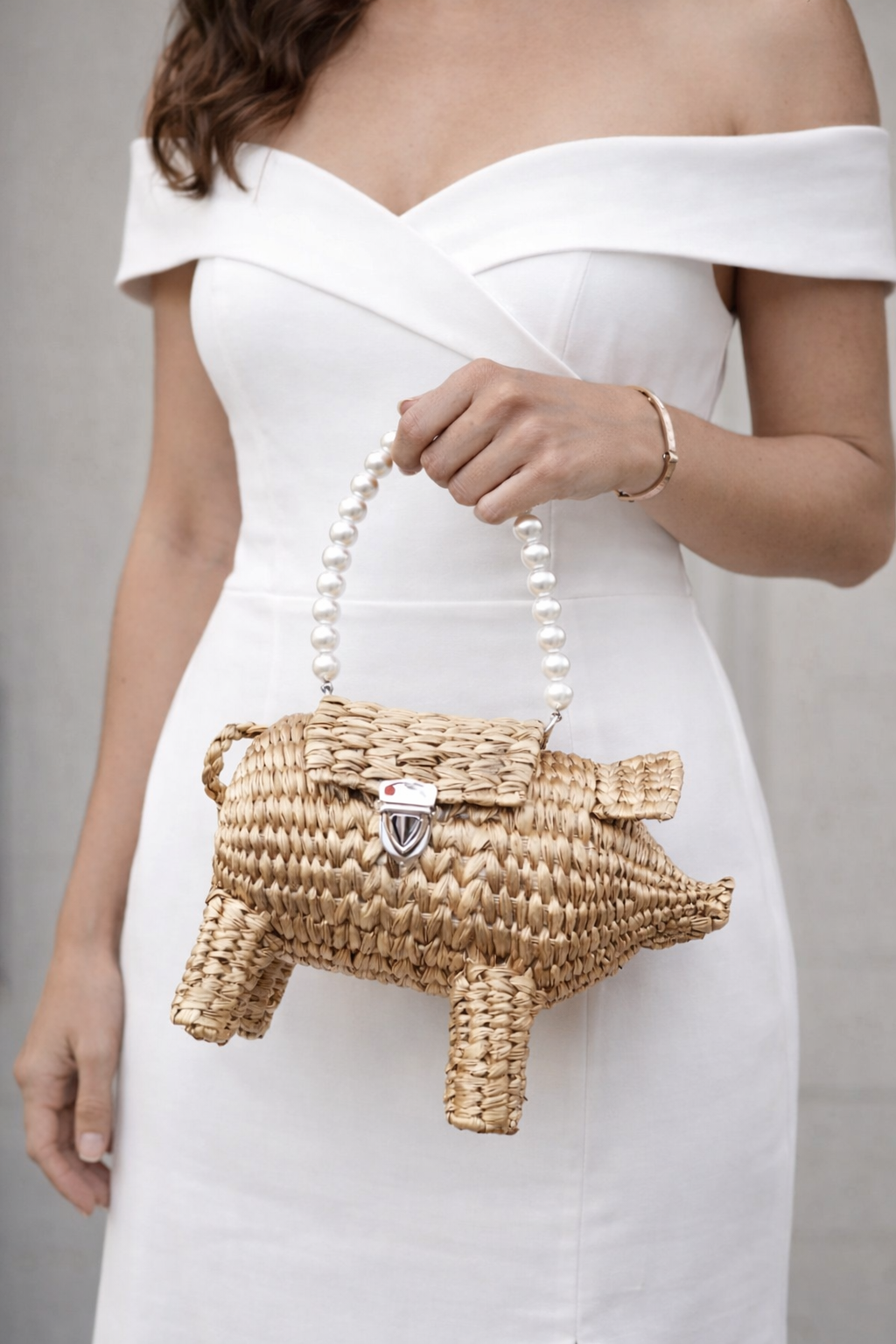 Wedding guest outfit styled with pig straw clutch bag, artisan woven evening purse, statement animal clutch for formal occasions