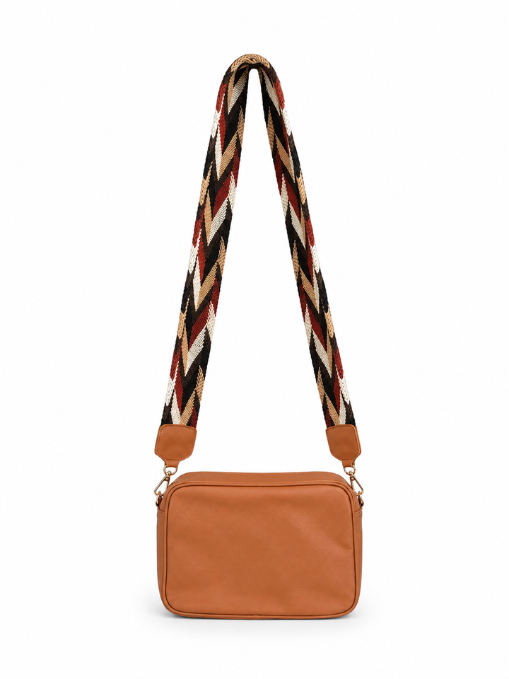 Genuine leather crossbody bag with Wayuu woven strap on white background