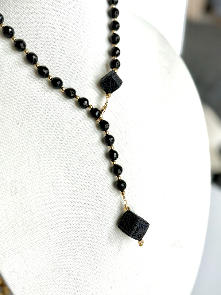 Artisan black clay Oaxaca necklace on pure white background, modern boho Mexican jewelry handcrafted with genuine Barro Negro ceramic details and black beaded chain by Bootsologie.