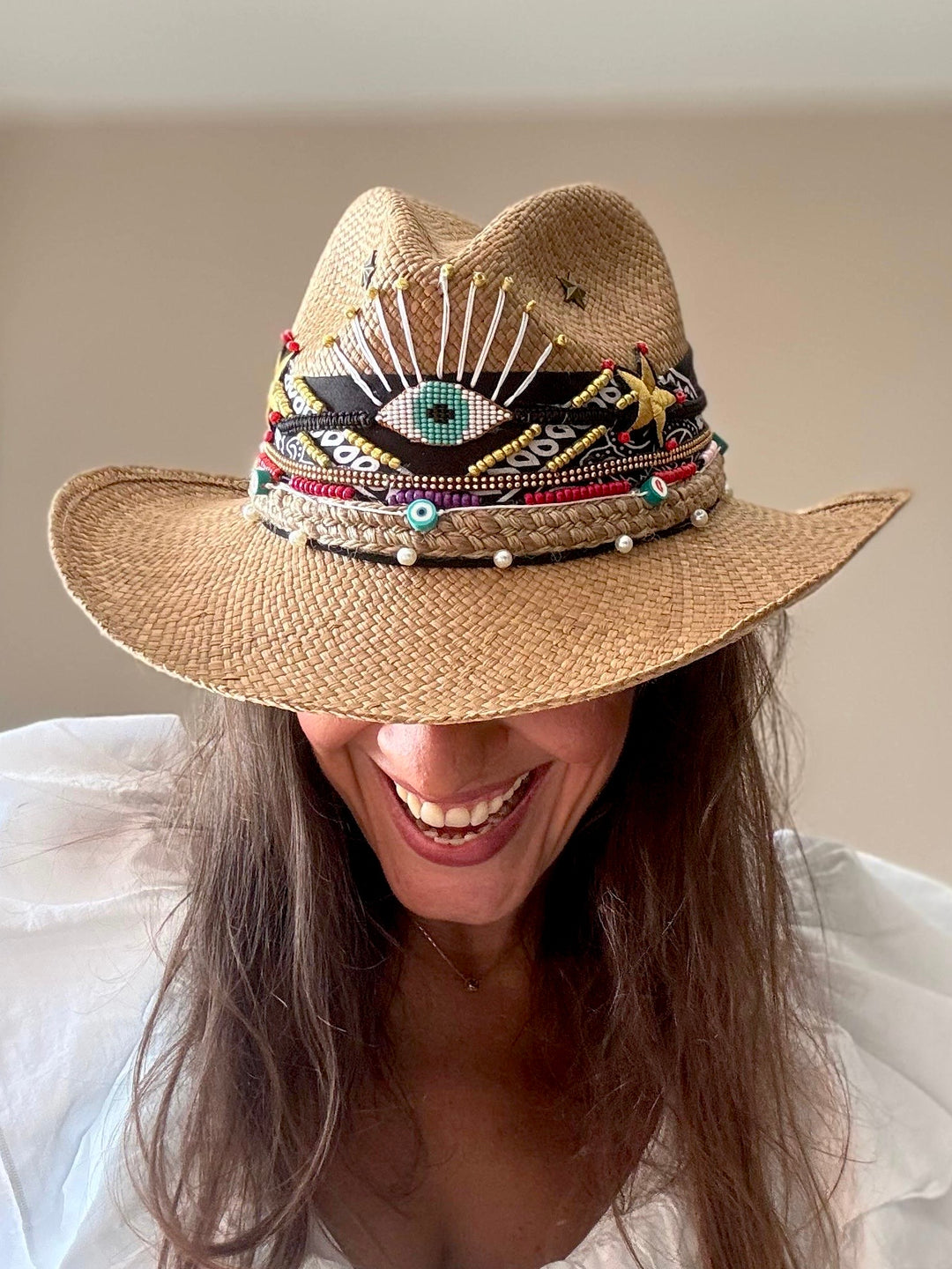 Model wearing artisan Panama cowboy hat with colorful embellishments and coastal cowgirl styling