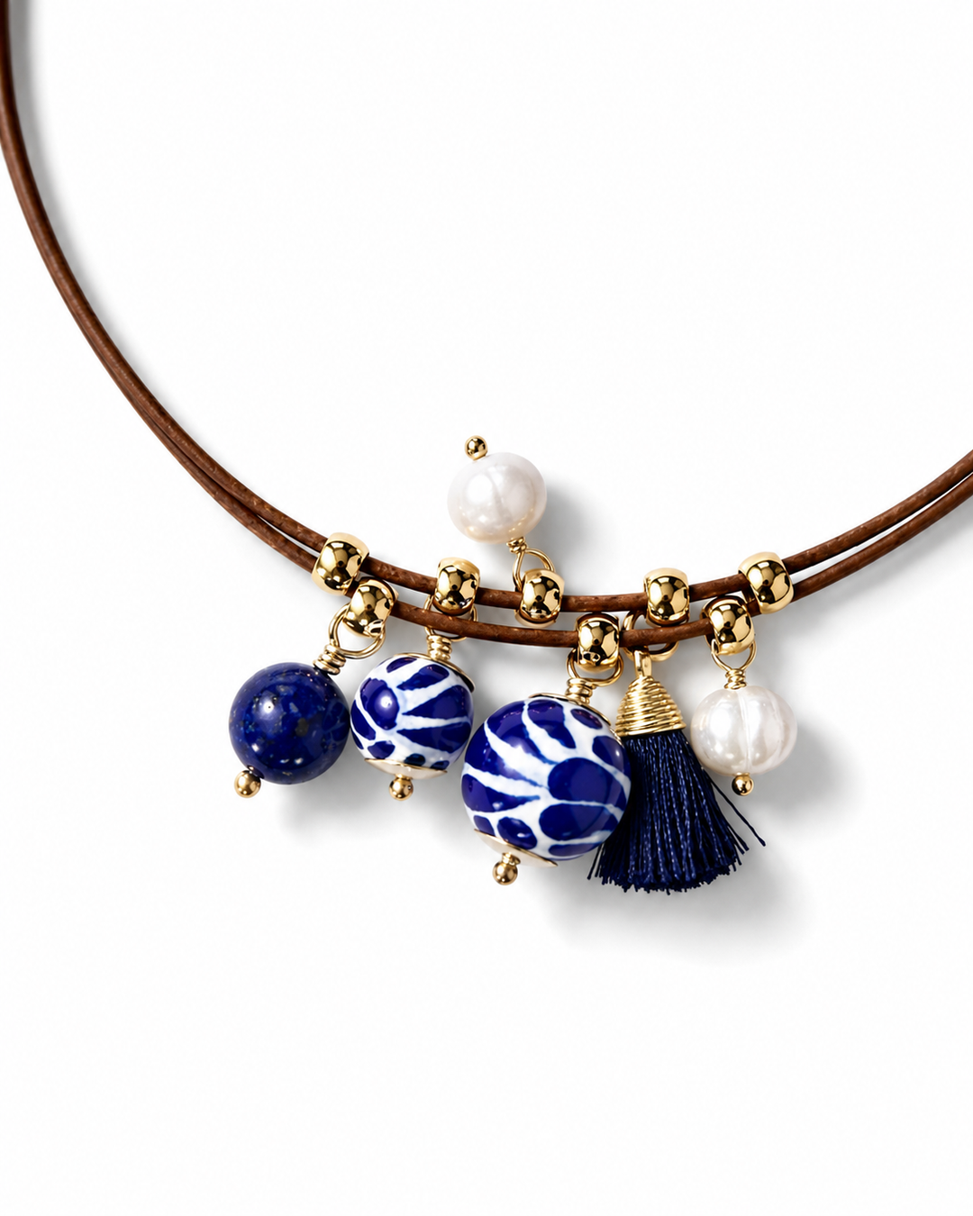 Close-up of genuine Talavera necklace showing hand-painted ceramic beads, freshwater pearls, navy tassel, and leather cord