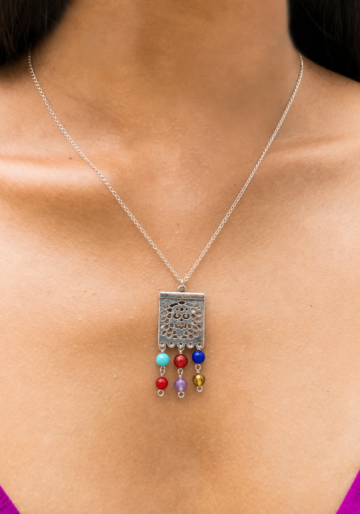 Woman wearing handmade Mexican silver papel picado necklace by Bootsologie