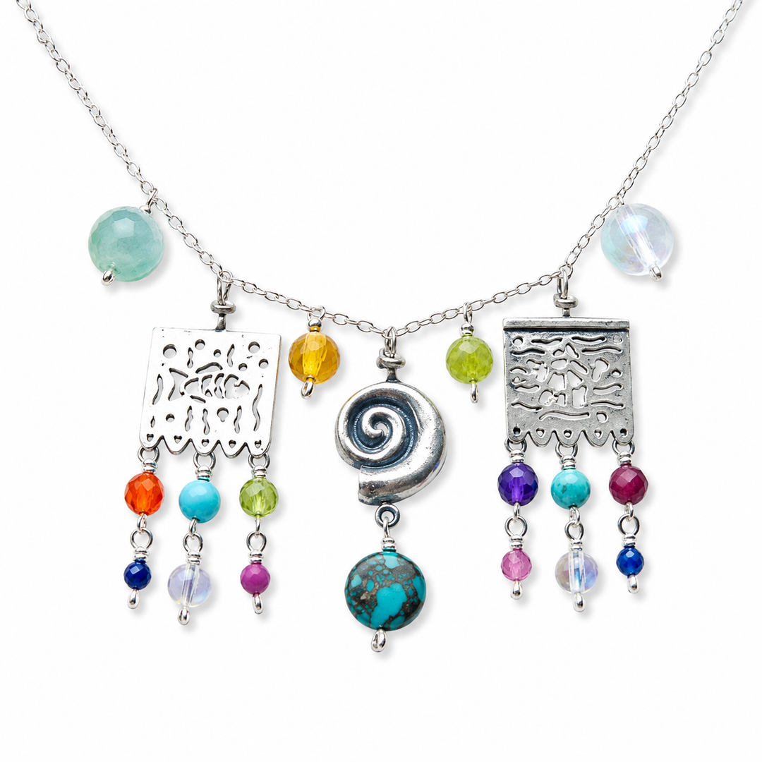Close-up of papel picado silver necklace with jade gemstone and multicolor natural stone drops