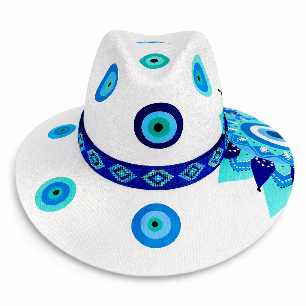 Hand painted Mexican eye motif hat on white background with colorful artwork, wide brim shape, and Huichol beaded band by Bootsologie