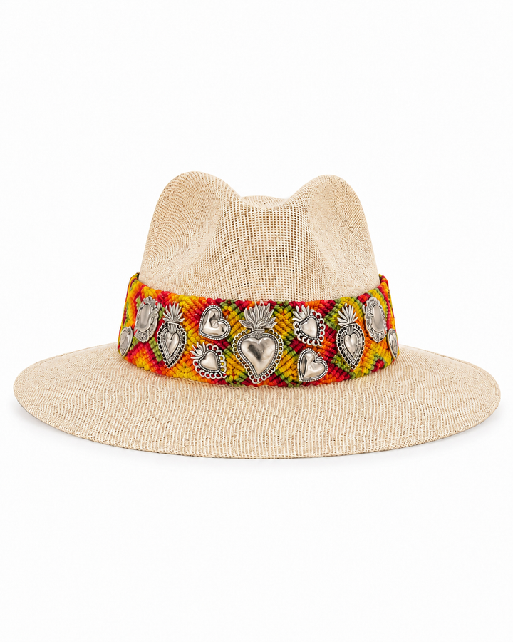 Handmade straw fedora hat with colorful Oaxacan knitted band and silver heart charms on white background