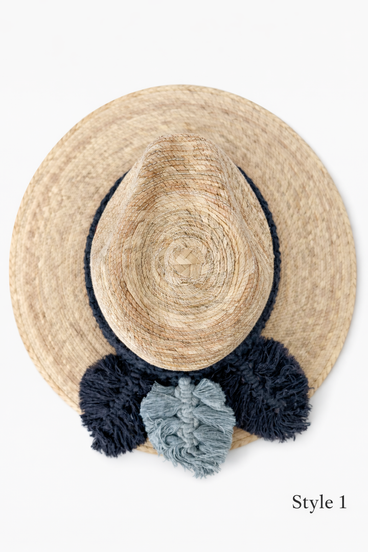 Wide brim straw sun hat with handmade macrame band and decorative tassels, boho summer beach hat for women by Bootsologie isolated on white
