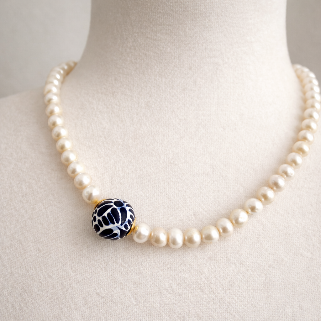 Close up of hand painted Talavera pendant with pearl detail
