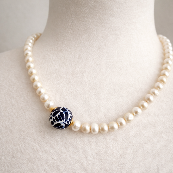 Close up of hand painted Talavera pendant with pearl detail