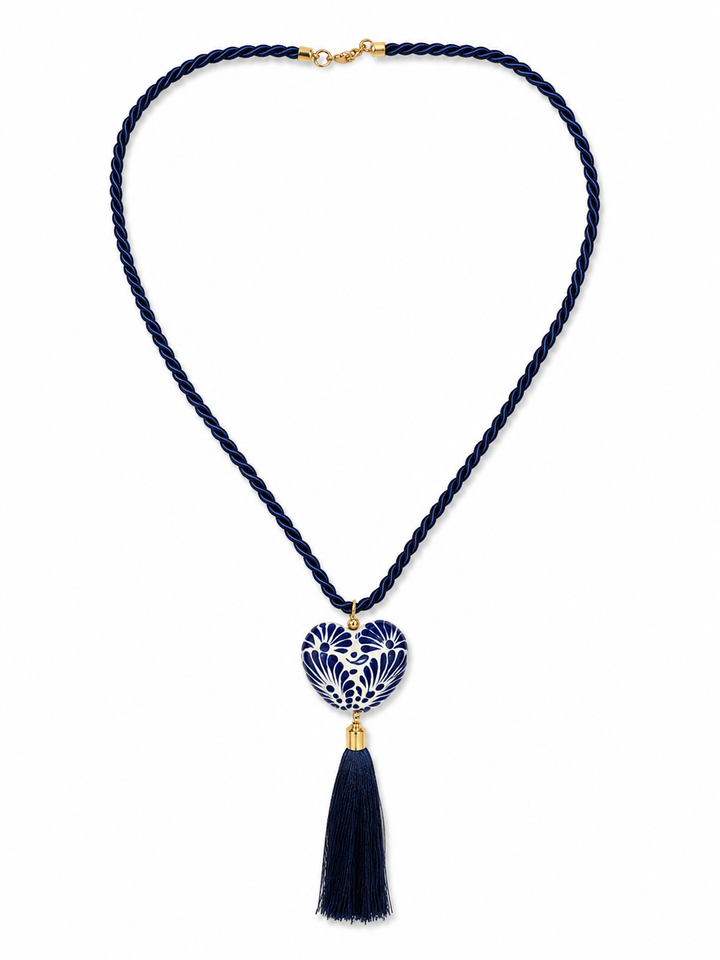 Model wearing Mexican Talavera heart necklace with navy cord and tassel, artisan statement jewelry by Bootsologie