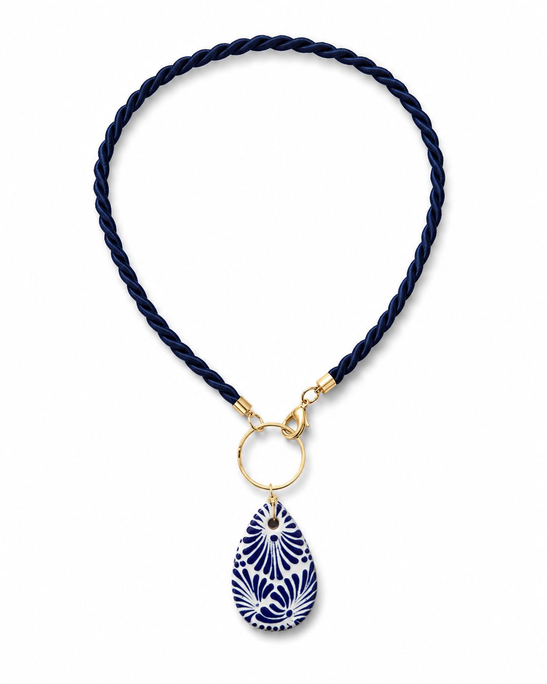 Blue and white Talavera ceramic teardrop necklace with navy cord and gold-tone hardware on white background