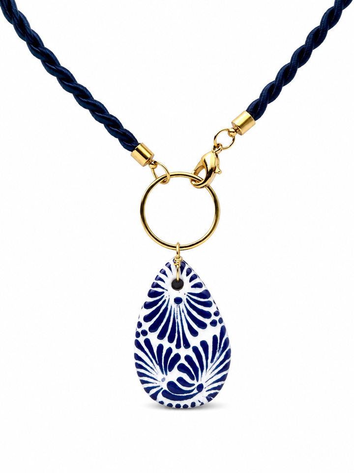 Close-up of genuine Talavera necklace showing hand-painted ceramic teardrop pendant and navy twisted cord