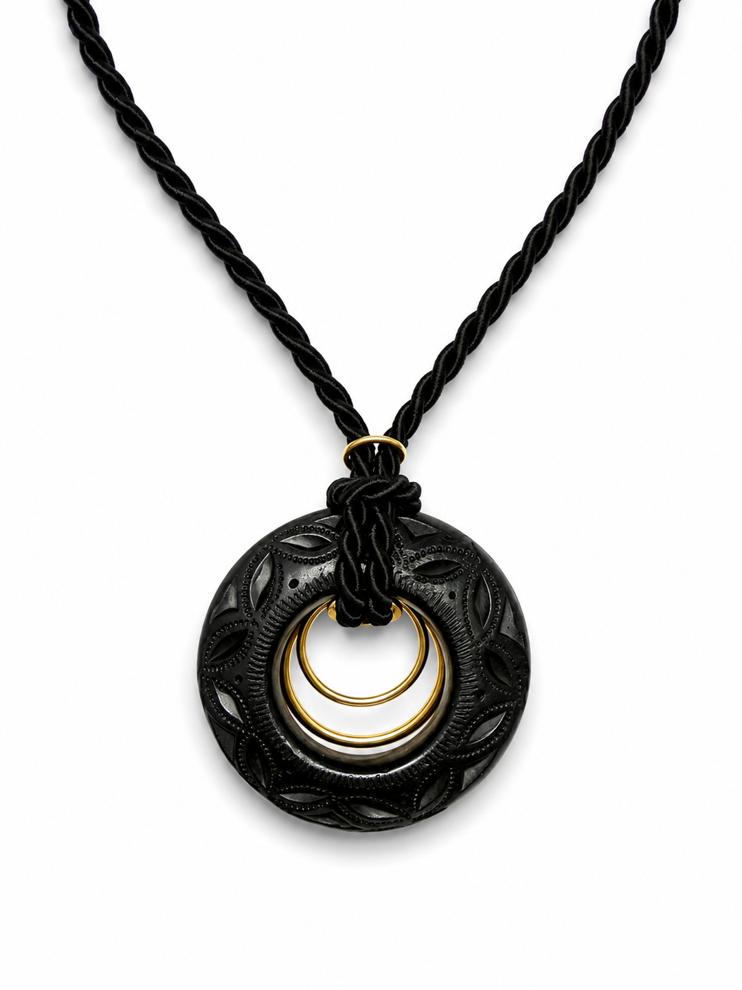 Close-up of authentic Oaxaca Barro Negro necklace showcasing intricate hand carved black clay texture and artisan gold ring detail on white background
