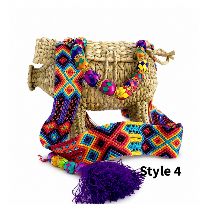Handmade pig straw crossbody bag with colorful woven strap, bead accents and tassel on white background
