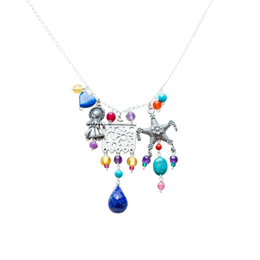 Handmade Mexican papel picado sterling silver necklace on white background