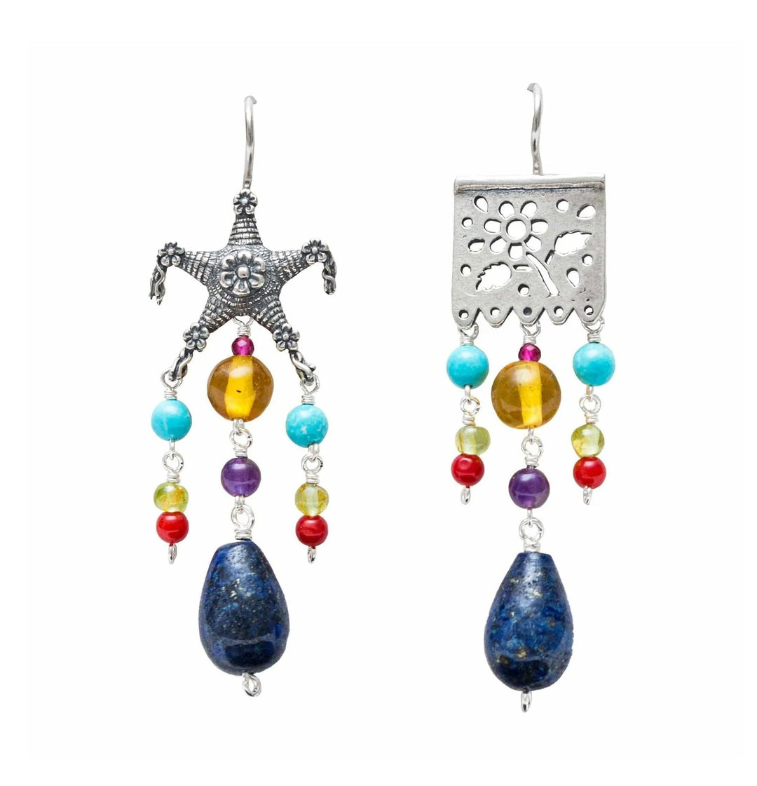Handmade Mexican silver papel picado earrings with natural lapis lazuli stones on white background