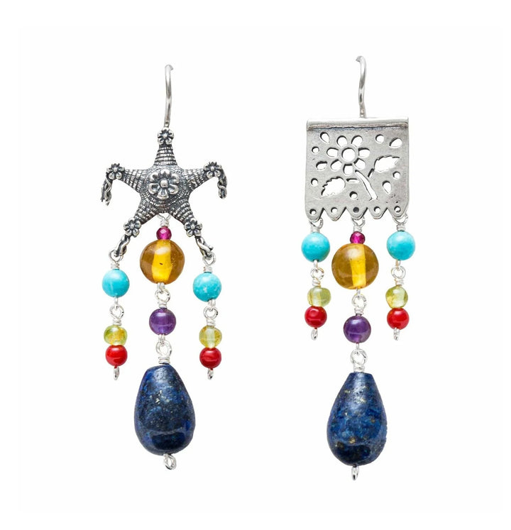 Handmade Mexican silver papel picado earrings with natural lapis lazuli stones on white background