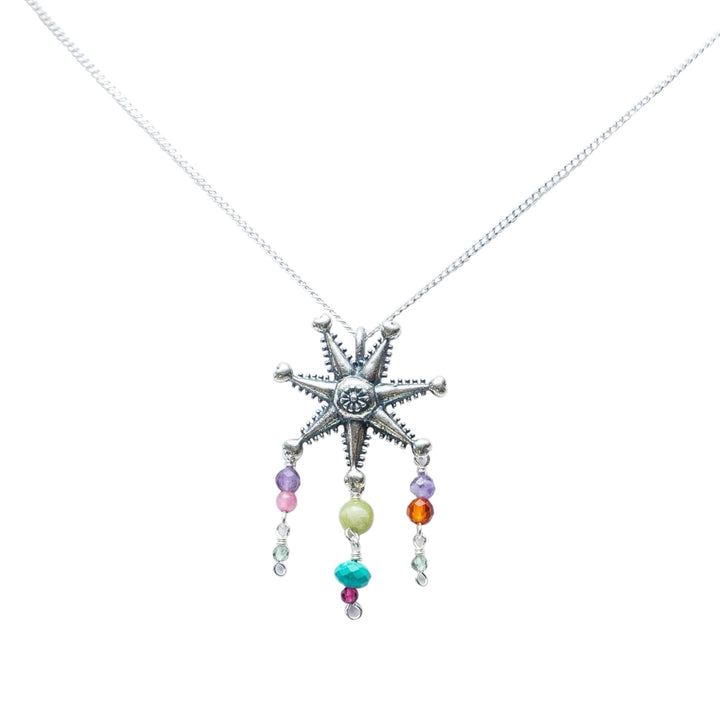 Mexican silver piñata necklace with colorful gemstone drops on white background