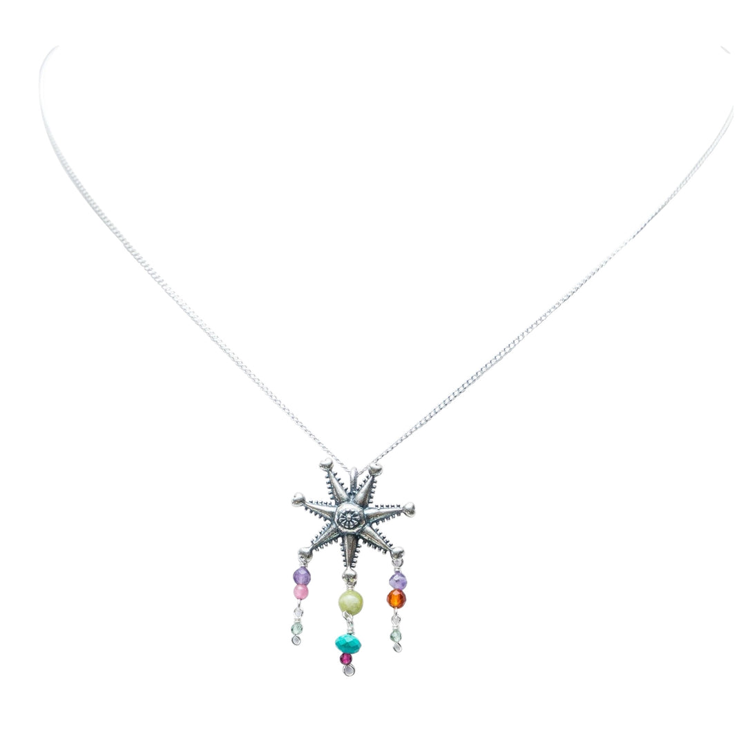 Mexican silver piñata necklace with colorful gemstone drops on white background