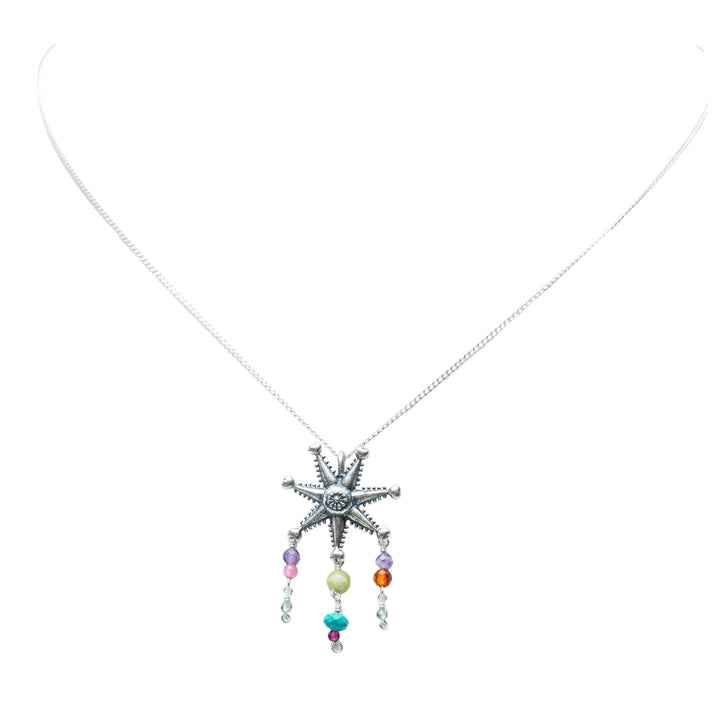 Mexican silver piñata necklace with colorful gemstone drops on white background