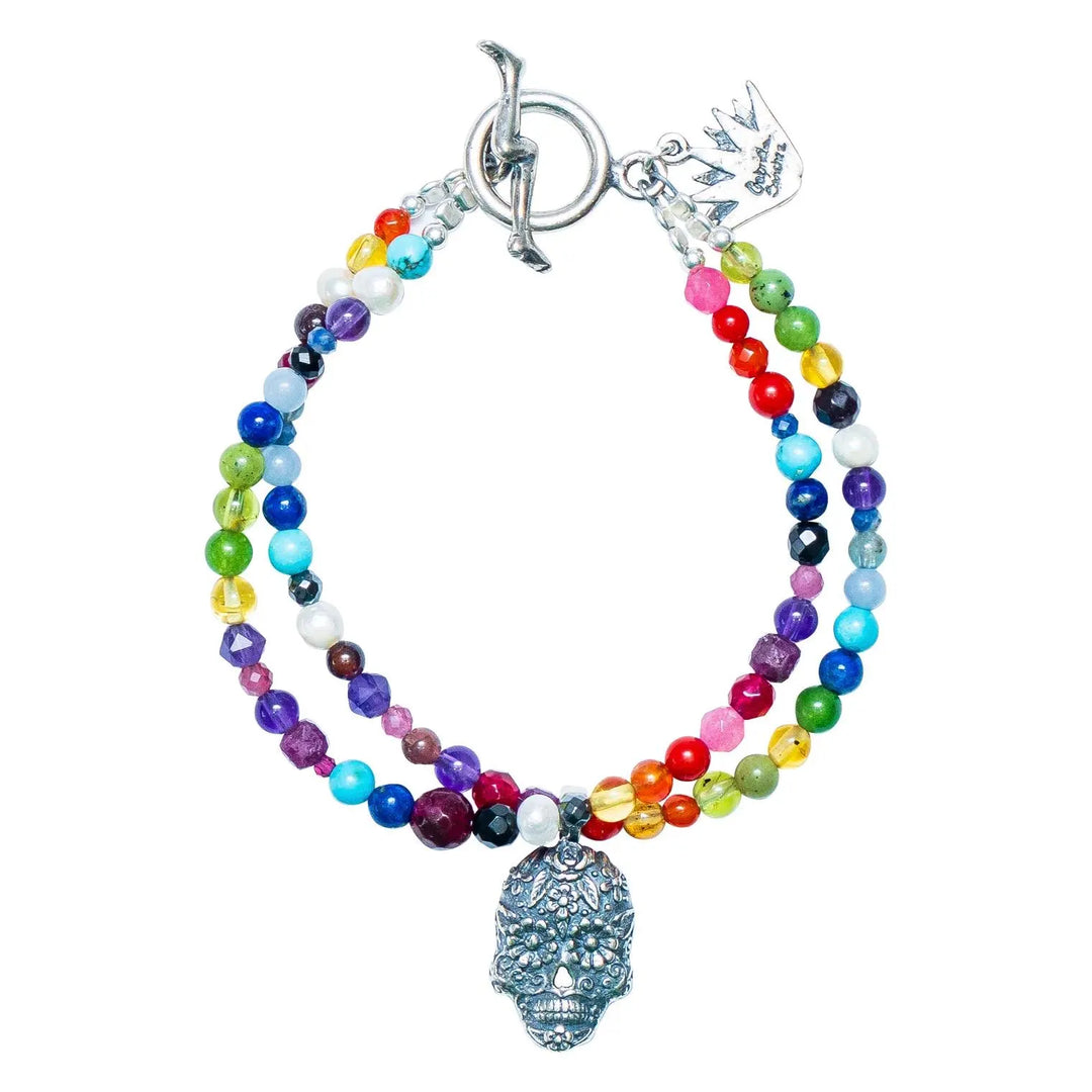 Mexican Catrina silver charm bracelet with jade gemstone accents on white background