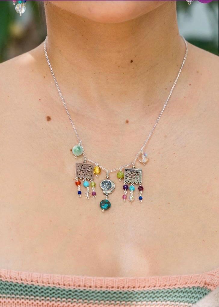 Woman wearing Mexican papel picado jade silver necklace with colorful gemstones