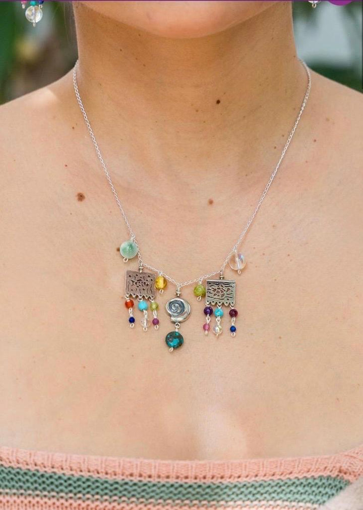 Woman wearing Mexican papel picado jade silver necklace with colorful gemstones