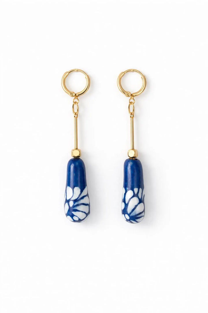Blue and white Mexican Talavera ceramic drop earrings with gold plated brass hoops on white background
