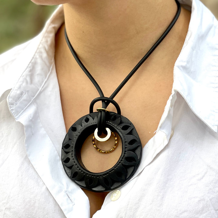 Close-up lifestyle image of model wearing authentic Oaxaca black clay necklace featuring bold handcrafted pendant and elevated bohemian styling