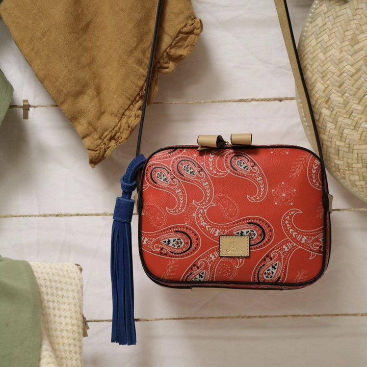Mexican leather crossbody bag with bandana print detail styled on linen surface, suede interior artisan handbag, Bootsologie